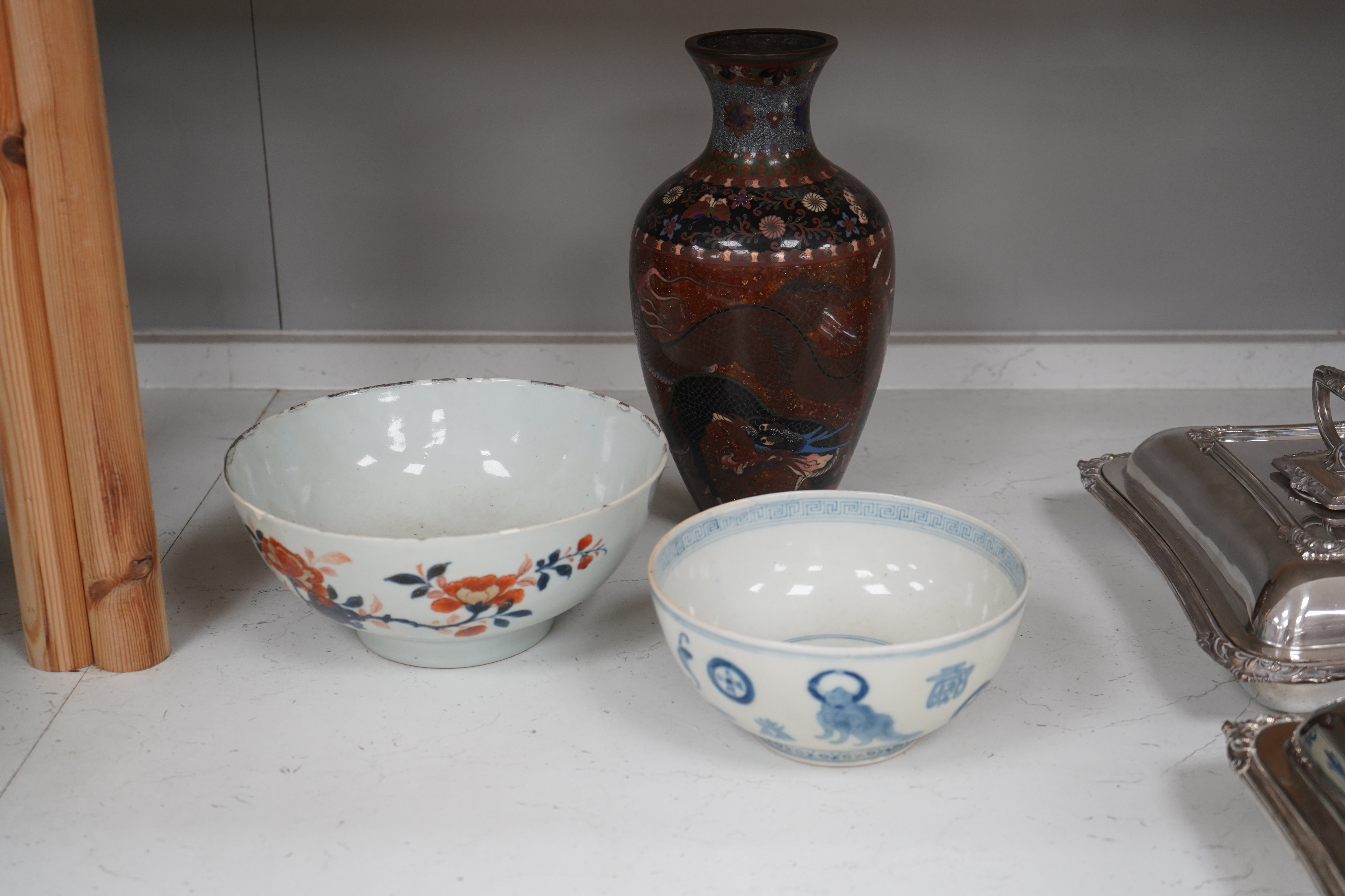 Three pieces of Chinese and Japanese ceramics to include an 18th century Chinese export bowl and a cloisonné ‘dragon’ vase, 31cm high. Condition - fair